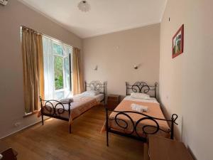 a bedroom with two beds and a window at Laguna Hotel in Ureki