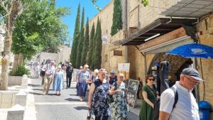 a group of people walking down a street at La Casetta in Nazareth