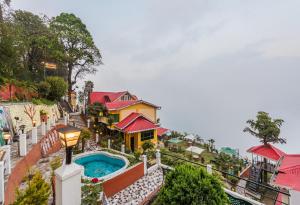 a house with a swimming pool on a balcony at Udaan Nirvana Resort, Darjeeling in Darjeeling