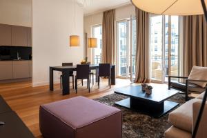 a living room with a table and a couch at The Wellem Residences in Düsseldorf