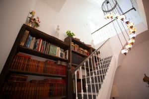 a staircase with book shelves filled with books at El Palacete de Cuevas in Cuevas del Almanzora