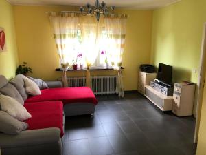 a living room with a couch and a tv at Traumhaftes Apartment in Mönchengladbach Ohler in Mönchengladbach