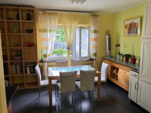 a dining room with a table and chairs and a window at Traumhaftes Apartment in Mönchengladbach Ohler in Mönchengladbach