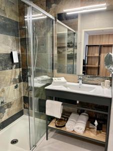 a bathroom with a sink and a shower at Golden Tulip Martigues Provence in Martigues