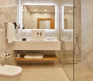 a bathroom with a sink and a toilet and a shower at Rammos Hotel Bodrum - Special Class in Bodrum City