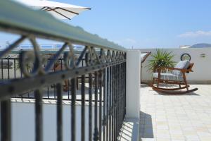 a railing on a balcony with a table and chairs at Dar Hammamet Guest House & Hammam in Hammamet