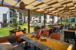 a patio at a restaurant with tables and chairs at DADYA BORA HOTEL in Emecik