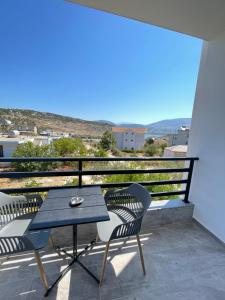 a patio with a table and chairs on a balcony at Villa Denis Ksamil in Ksamil