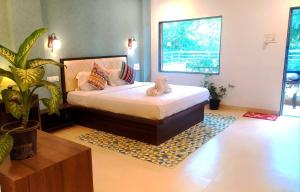 a bedroom with a bed with a stuffed animal on it at Hiranya Nature Retreat in Daulatābād