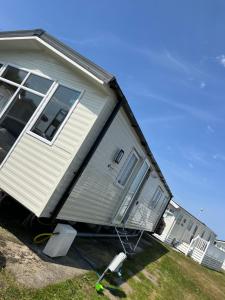 a house that is sitting on the side of a yard at Newquay Bay Resort 181 in Newquay Bay Resort