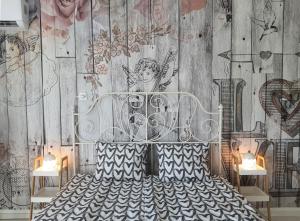 a bedroom with a bed with a drawing on the wall at Hegyalja Apartman in Miskolc