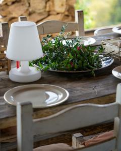 een tafel met een lamp en een bord bloemen bij bnbthekey 1,2,3 in Olmedo