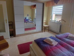 a bedroom with two beds and a large mirror at Ferienwohnung Familie Windt in Feldberg