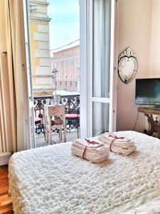 a bedroom with a bed with two towels on it at Residenza Santi Muratori in Ravenna