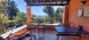 a balcony with a table and chairs and a view at Villa Leena in Paramonas