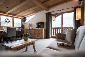 a living room with a couch and a table at Residence Cesa Sassela in Ortisei