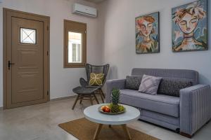 a living room with a couch and a table at Andy's & Hari's Elegant Town Studios in Zakynthos Town