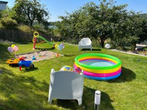 a backyard with a playground with a pool and play equipment at ALEKSANDRA in Wiele