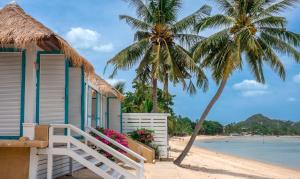 a house on the beach with palm trees at Sand Sea Resort & Spa - Lamai Beach , Koh Samui in Lamai