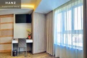 a room with a desk and a large window at HANZ Premium Mai Vy Hotel in Tây Ninh