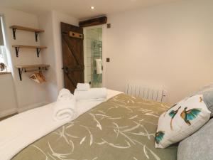 a bedroom with a bed with towels on it at Darrowby Barn in Skipton