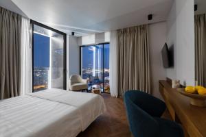 a hotel room with a bed and a large window at Neoma in Athens