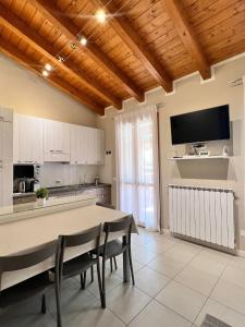 uma cozinha com mesa e cadeiras num quarto em Appartamento Corina em Sirmione