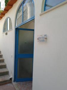 a garage door with a sign on the side of a building at Nuida Casa Vacanze in Capri