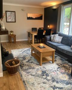 a living room with a couch and a table at Cedar Lodge in Oban