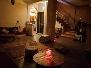 a living room with a table with a candle on the floor at Seven Waves in Imsouane