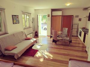 a living room with a couch and a table at Green house in Čavle