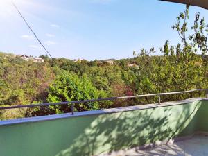a balcony with a view of trees and bushes at Green house in Čavle