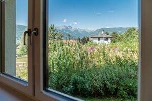 a window with a view of a field of grass at Hotel Die Metzgerstubn in Sankt Michael im Lungau