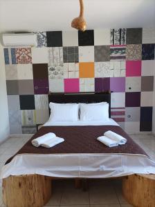 a bedroom with a large bed with towels on it at thassossweethome in Limenas
