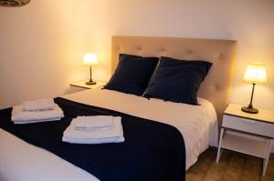 a bedroom with a large bed with towels on it at Casa Vitorino in Sagres