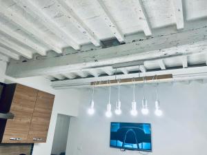 a group of lights hanging from a ceiling at new apartment 2 minute from the port in Livorno