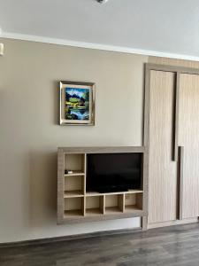 a living room with a tv on a wall at Villa Orange in Sozopol
