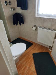 a bathroom with a white toilet and a window at Fewo Ostsee in Graal-Müritz