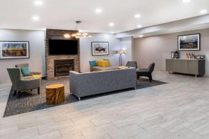 a lobby with a couch and chairs and a fireplace at Hawthorn Extended Stay by Wyndham Ardmore in Ardmore
