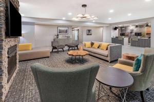 a living room with couches and chairs at Hawthorn Extended Stay by Wyndham Ardmore in Ardmore