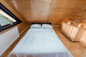 a bed in the middle of a tiny house at La Cabană in Vişeu de Jos