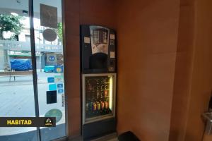 uma máquina de venda automática do lado de um edifício em Hostal Rambla em Sant Boi del Llobregat