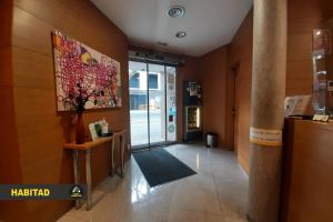 a hallway with a lobby with a door to a building at Hostal Rambla in Sant Boi del Llobregat