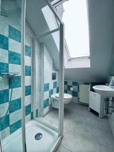 a bathroom with a shower and a toilet and a sink at Heidrun's Home in Altendiez