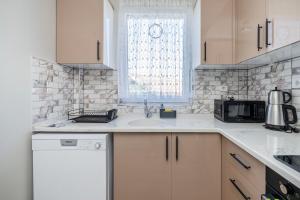 a white kitchen with a sink and a microwave at Spacious apartment in the historical center of Bursa in Bursa