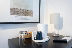 a desk with a blender and a lamp on it at The Royal Burnham Yacht Club in Burnham on Crouch