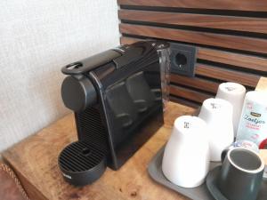a black toaster sitting on top of a wooden table at Historic Centre Hotel in Amsterdam
