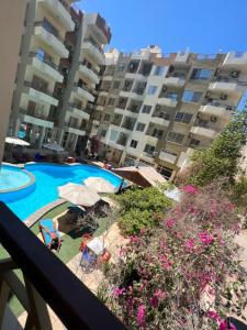 a view of a swimming pool from a balcony of a apartment at Paradise Hill Compound in Hurghada