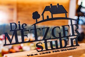 a black sign that reads die merrier shuttle at Hotel Die Metzgerstubn in Sankt Michael im Lungau