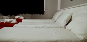 a white bed with white pillows and pillows at Fairmount Hotel in Bournemouth